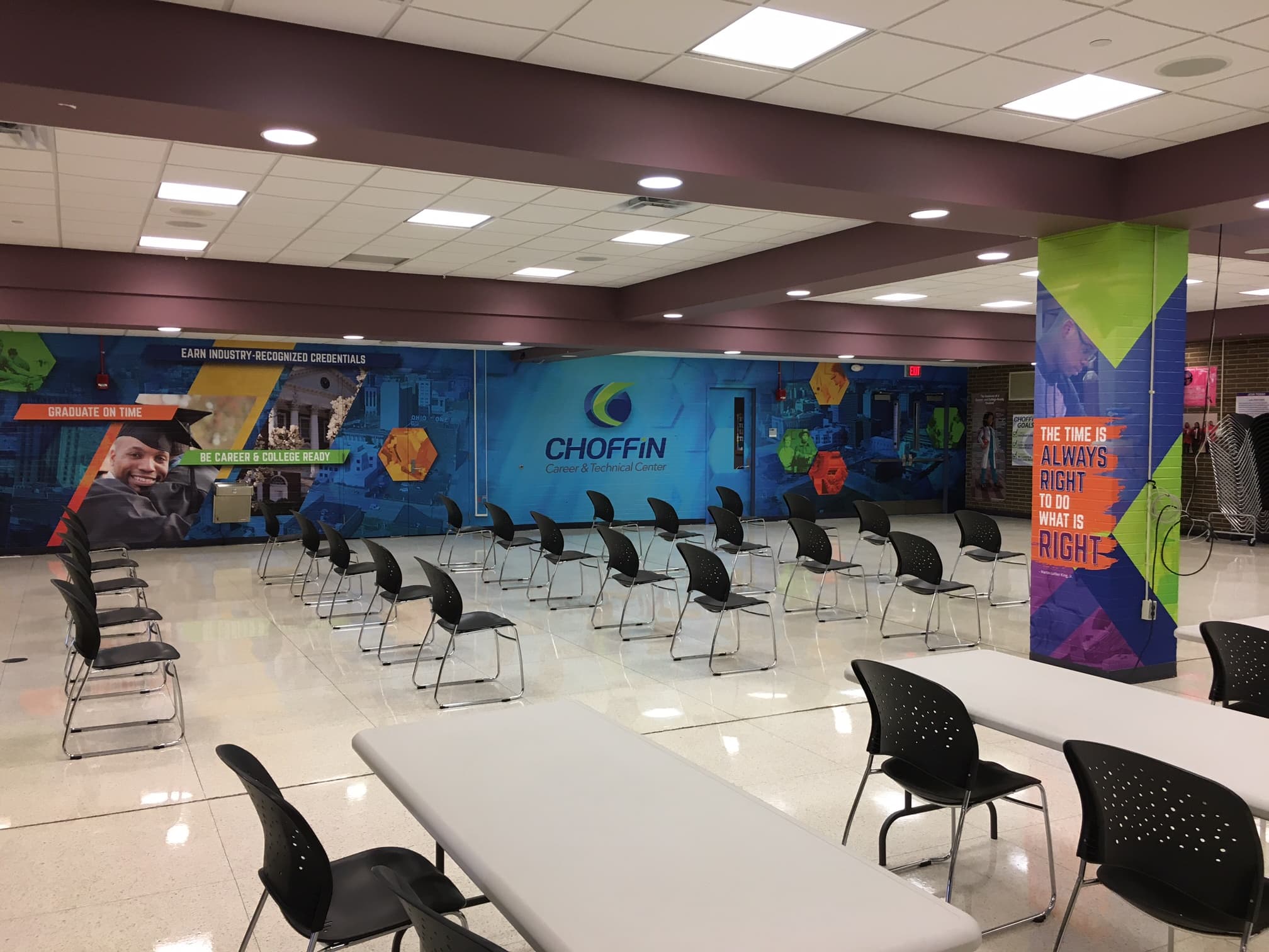 Choffin cafeteria back brick wall featuring large branded graphics