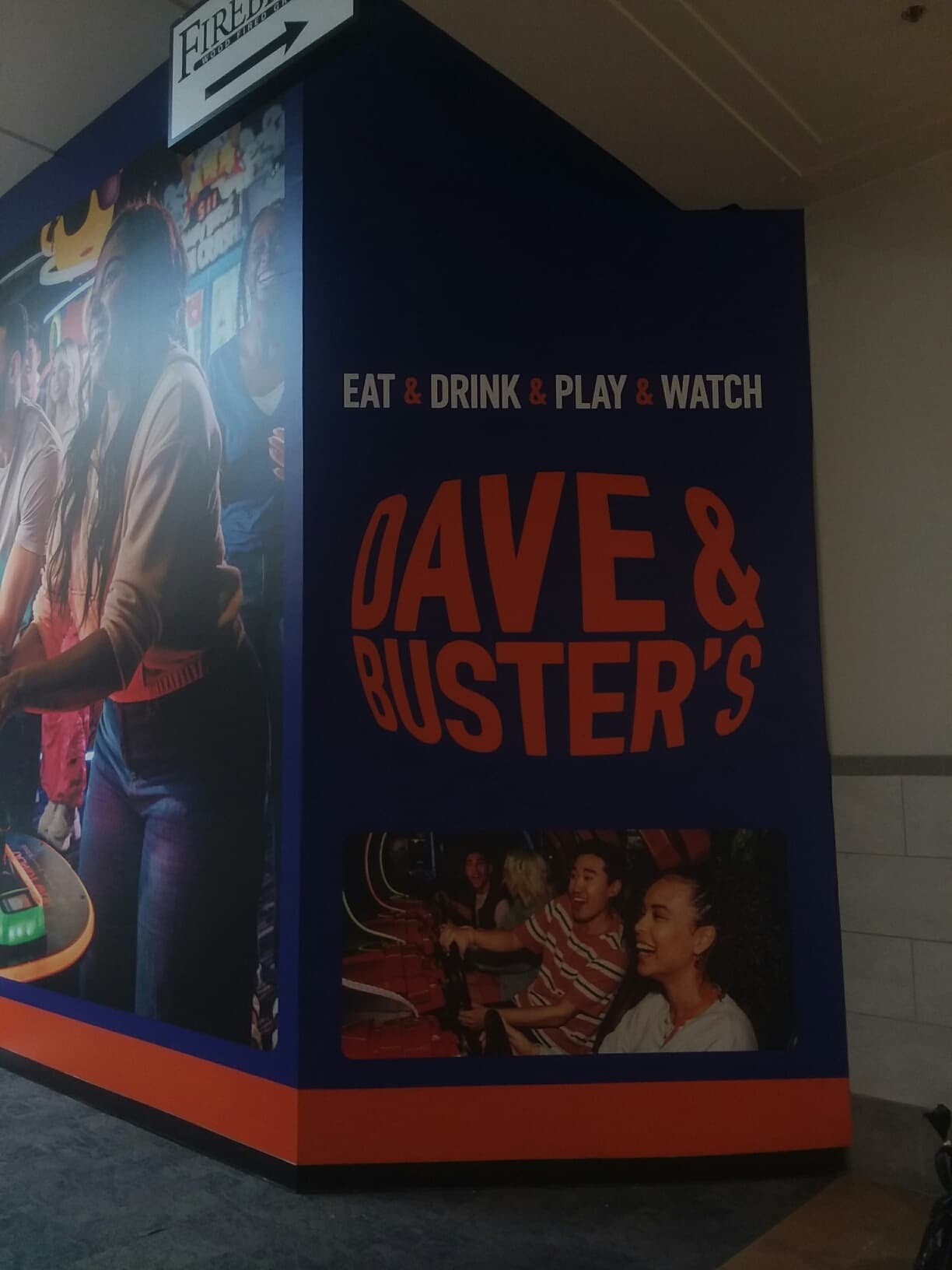 Dave & Buster's full-bleed coming-soon barricade wrap with Eat Drink Play Watch typography