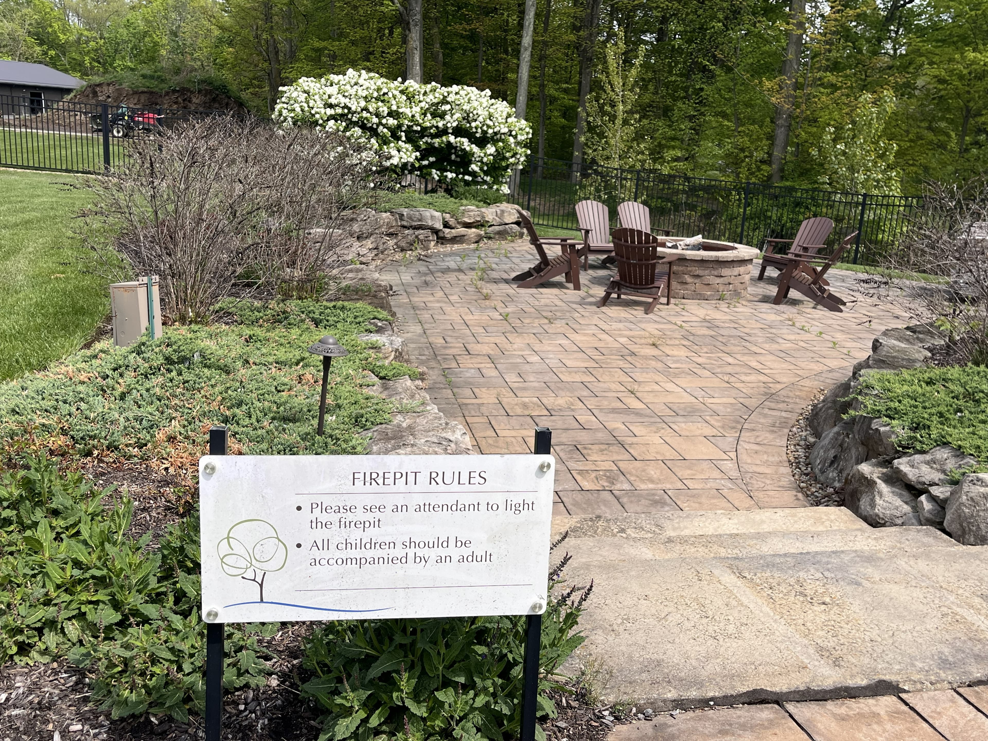 Firepit area at The Lake Club with branded signage