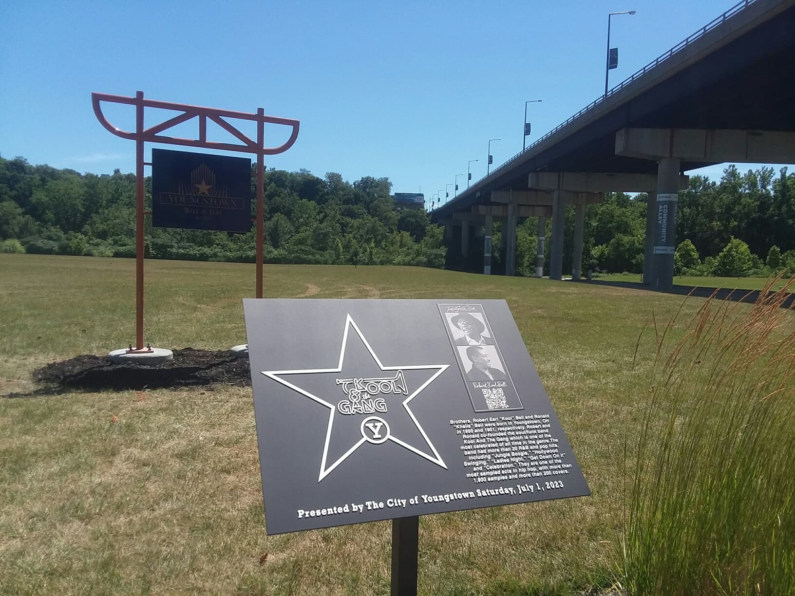 Kool & The Gang Walk of Fame plaque in front of the truss sign with the bridge behind